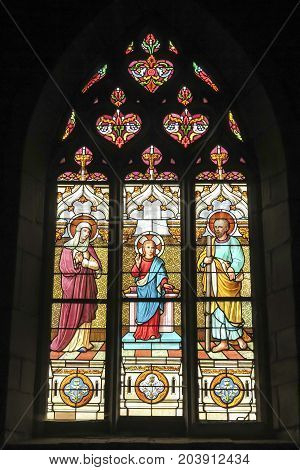 Iffendic France - September 9 2016: Stained glass window in the Church of Saint Eloi in Iffendic France. Place adoption by St Louis Marie de Montfort First Holy Communion.