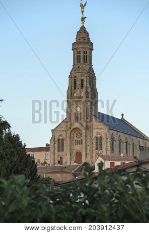 Church of Saint Michael in Saint-Michel-Mont-Mercure France with a large figure of the Archangel Michael at the top of the tower