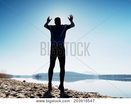 Jumping Man. Sportsman Crazy Jumping  And Jogging On Beach During The Sunrise