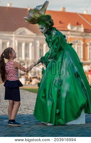 TIMISOARA, ROMANIA - September 08, 2017: Portrait of a woman in green dress at the CheckArt Carnival. Living statue. Union Square.