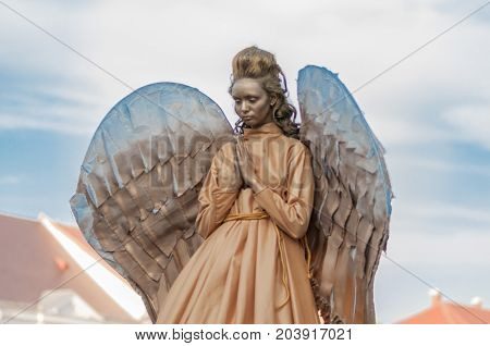 TIMISOARA, ROMANIA - September 08, 2017: Portrait of a woman in angel costume at the CheckArt Carnaval. Living statue. Union Square.