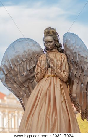 TIMISOARA, ROMANIA - September 08, 2017: Portrait of a woman in angel costume at the CheckArt Carnaval. Living statue. Union Square.