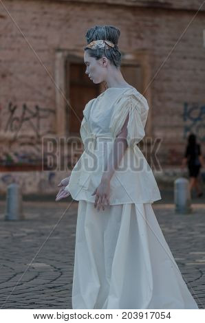 TIMISOARA, ROMANIA - September 08, 2017: Portrait of a woman in white dress at the CheckArt Carnaval. Living statue. Union Square.