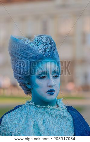 TIMISOARA, ROMANIA - September 08, 2017: Portrait of a woman in blue dress at the CheckArt Carnaval. Living statue. Union Square.