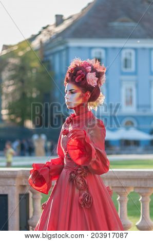 TIMISOARA, ROMANIA - September 08, 2017: Portrait of a woman in red dress at the CheckArt Carnaval. Living statue. Union Square.