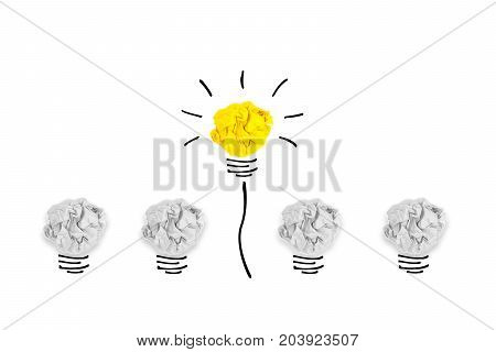 Creative concept. Yellow light bulb outstanding on bulb crumpled paper on white background