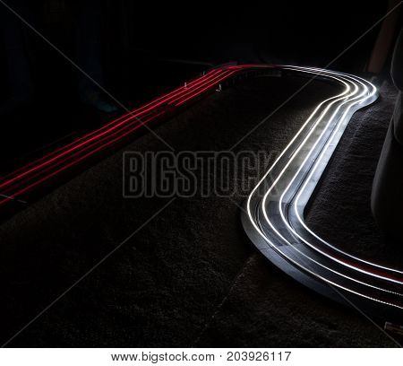 Utilizing two slot cars with headlights and taillights to paint with light.