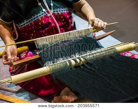 Local woman is making handicraft work with local loom