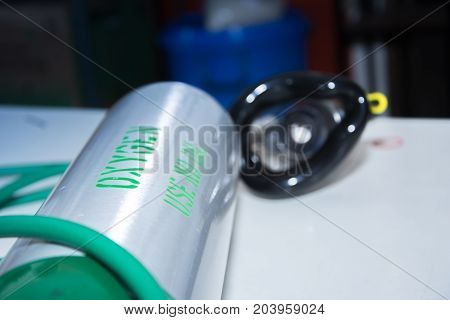 oxygen cylinder near mask selective focus text on tank
