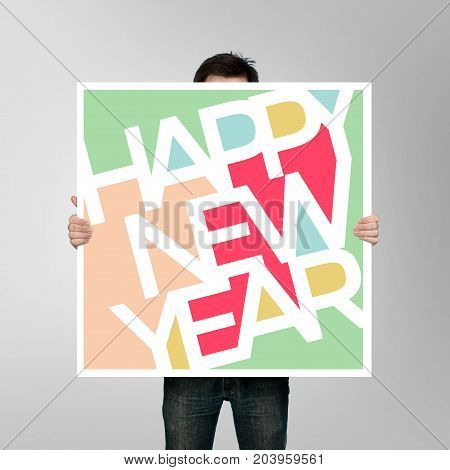 man holding christmas poster on gray background