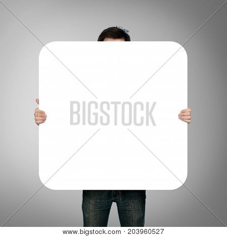 man holding blank poster on white background
