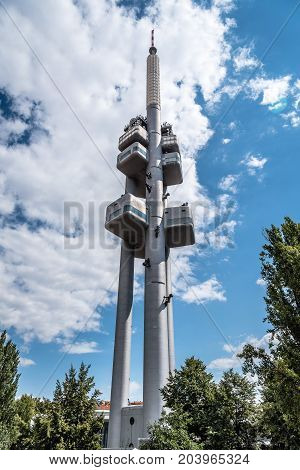 Prague, Czech Republic - August 21, 2017: Zizkov Television Tower in Prague. It is is a  transmitter tower and an example of high tech architecture. Low angle view a cloudy day of summer.