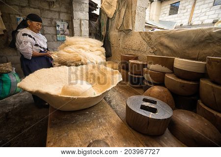 April 21 2017 Iluman Ecuador: wool hat and press forms on work bench in artisan shop
