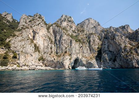 CAPRI ITALY - JUNE 13 2017: Boats with tourists near Grotta Bianca and Grotta Meravigliosa Capri Italy