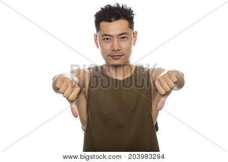 Athletic Asian male with trendy torn sleeveless shirt on a white background. He is displaying disapproval expressions or gestures. The handsome chinese or japanese man is muscular and physically fit