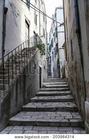Tourist city by the Adratic sea - Sibenik, Croatia. The old stones, narrow street and stairs.
