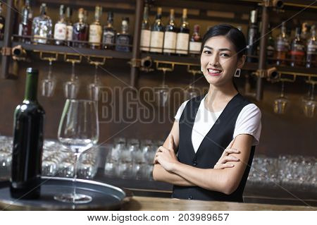 Young Asian Woman Waiter Restaurant Catering Service Happy Emotion. Woman Waiter Present Red-wine Fo
