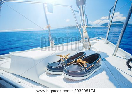 Navy top sider shoes with lifebuoy, binoculars on the wood background