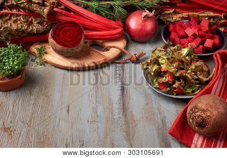 Food Background With Red Beet Root And Beet Leaves, Whole And Cut, And Space For Your Text