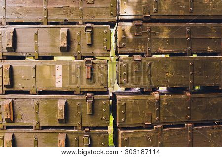 Military Green Boxes With Dangerous Explosives, Guns And Military Weaponry, Ready For Shipping, In A