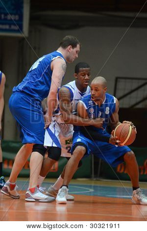 KAPOSVAR, HUNGARY â FEBRUARY 18: Kwadzo Ahelgebe (in white) in action at a Hungarian Championship basketball game with Kaposvar (white) vs. Fehervar (blue) on February 18, 2012 in Kaposvar, Hungary.
