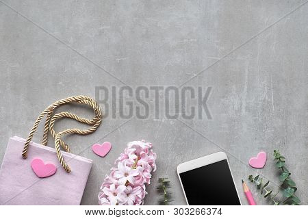 Springtime Flat Lay With Pearl Hyacinth Flower, Eucalyptus, Mobile Phone And Figt Bag On Stone Backg
