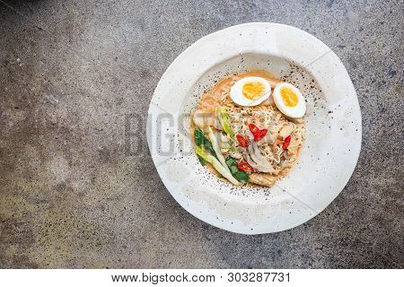 Japanese Ramen Noodle With Chicken, Shiitake Mushroms And Egg In White Bowl, Top View