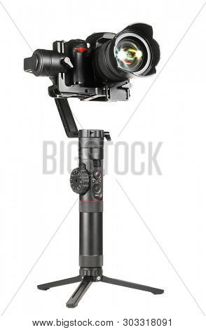 Gimbal three-axis motorized stabilizer with mounted DSLR camera isolated on white background