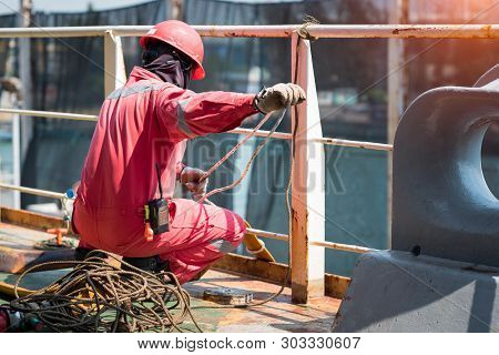 Foreman Using Walkie-talkie And Safety Helmet To Work In Cargo Ship