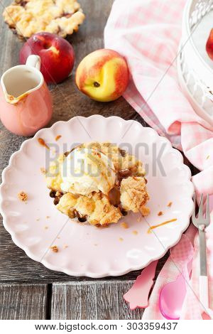 Peach Crumble A La Mode, With A Scoop Of Vanilla Ice Cream