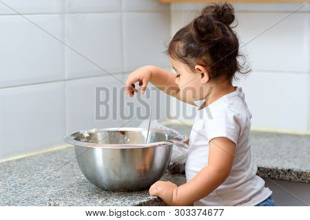 Kid Helping At House In Kittchen. Little Child Girl Making Pancakes From White Cheese On Marble Tabl