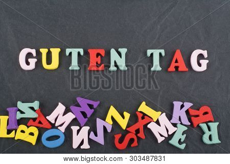 Guten Tag Word On Black Board Background Composed From Colorful Abc Alphabet Block Wooden Letters, C