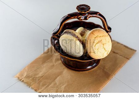 Delicious Argentinian Cookies Alfajores With Cream Dulce De Leche Close-up In A Brown Ceramic Vase O