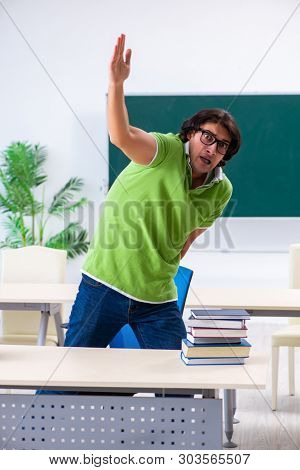 Male student suffering from urge in the classroom  