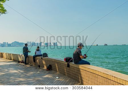 George Town Penang Island Malaysia. March 2019. A View Of Fisherman Along The Walkway Boulevards In 