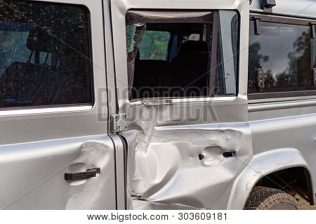 The Damaged Door Panel Of A Four Wheel Drive Vehicle Involved In A Highway Collision