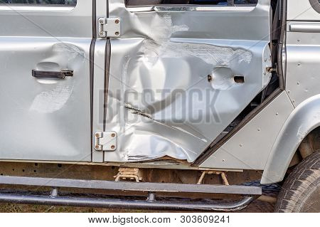 The Damaged Door Panel Of A Four Wheel Drive Vehicle Involved In A Highway Collision