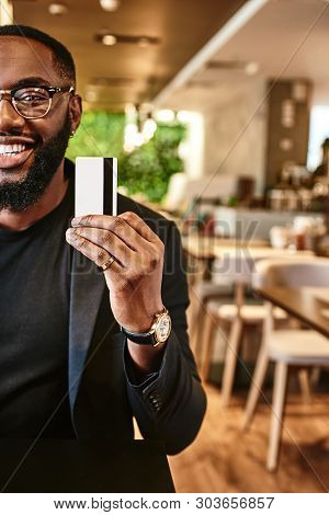 Price Is What You Pay. Value Is What You Get. Smiling African American Businessman Holds His Credit 