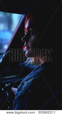 Woman In Car With Microphone At Night - Neon Light