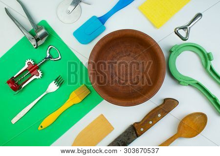Background Of Kitchen Utensils On White Wooden Kitchen Table. Tools. Top View.