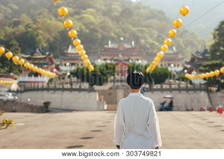 traveling woman praying at BaoHu Dimu Temple at Puli, Nantou, Taiwan, Asia