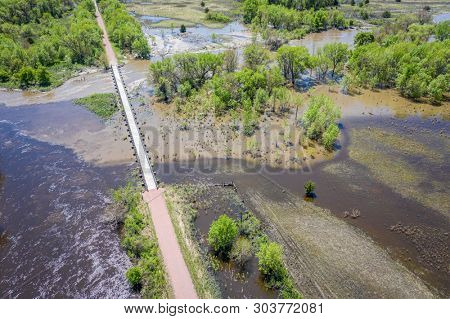 multi-use recreational Cowboy Trail crosses the flooded Elkhorn RIver near O'Neill in northern Nebraska, springtime scenery