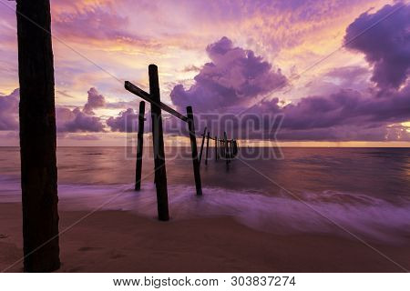 Beautiful Sunset Dramatic Sky Over Sea With Old Wooden Bridge At Khao Pilai In Phang- Nga Thailand.