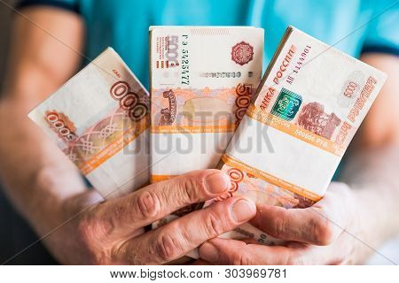 Denominations Of Five Thousand Russian Rubles. Bundle Of Banknotes Isolated In Male Hand.5000 Rubles