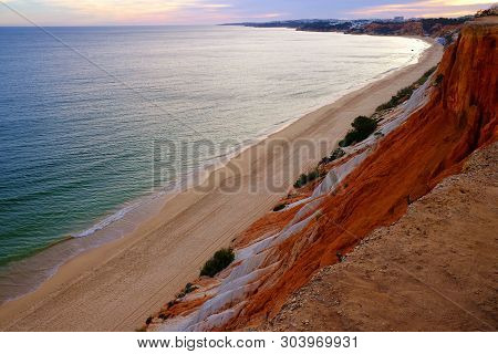 Aerial View On Praia Da Falesia - Falesia Beach In Algarve, Portugal On Sunset.