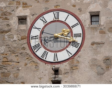 Old Clock On The City Tower Of Waidhofen An Der Ybbs With Ornate Golden Hands And Roman Numbers