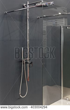Shower With Glass Divider In Grey Bathroom
