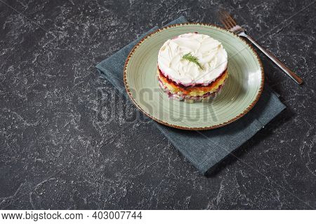 Russian Traditional New Year Salad Herring Under Fur Coat Shuba On Black Stone Table. Copy Space