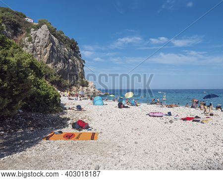 Cala Gonone, Sardinia, Italy, September 9, 2020: Cala Fuili Beach With Sunbathing People And Tourist