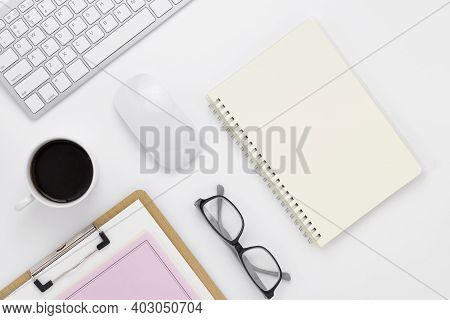Minimal Office Desk Table Top View With Office Supply And Coffee Cup On A White Table With Copy Spac